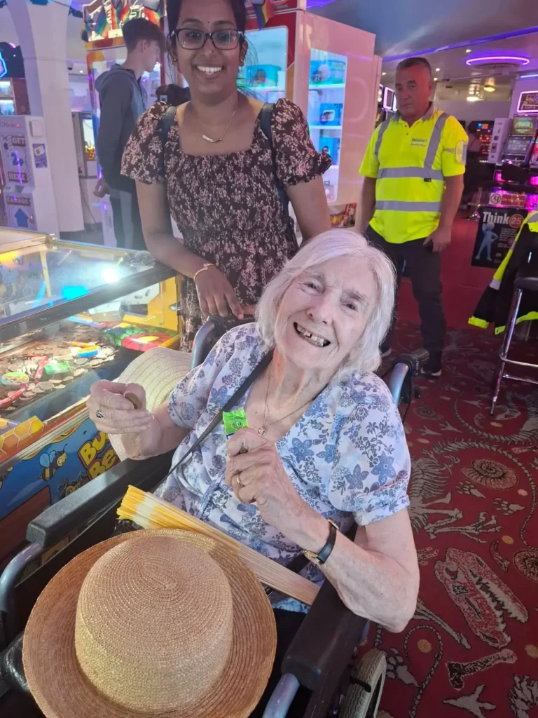 a Hampden Hall resident playing on the coin machines in the arcade