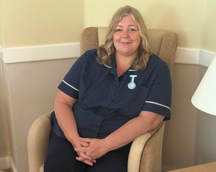 Jo Massey, the Unit Manager at Hampden Hall sitting in a chair.